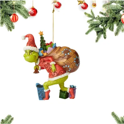 A Christmas ornament of the Grinch carrying a sack of gifts.