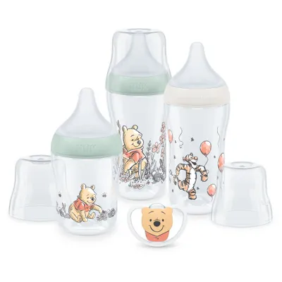 A set of baby bottles and a pacifier featuring Winnie the Pooh characters.