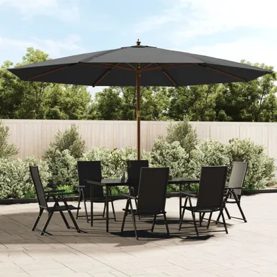 An outdoor patio set with a large umbrella, table, and chairs.