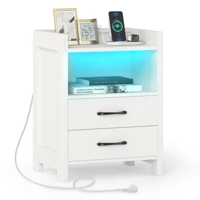 A white nightstand with two drawers, an open shelf with blue LED lighting, and decorative items on top.