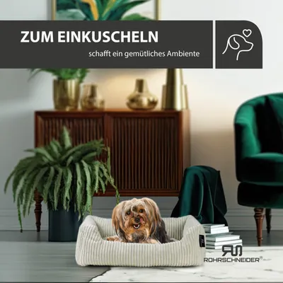 A dog is resting in a dog bed in a living room setting.