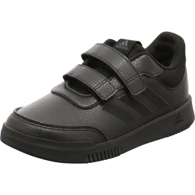 A black Adidas sneaker with velcro straps is shown against a white background.