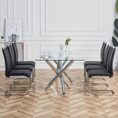 A dining set with a glass table and chairs in a room.