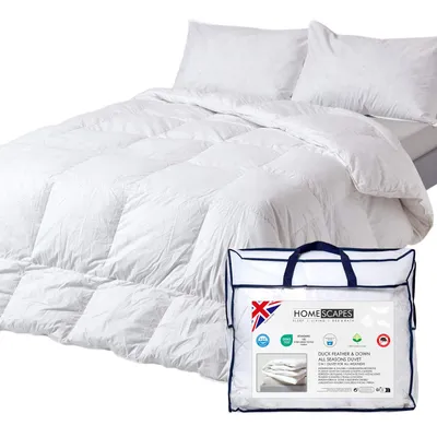 A white duvet and two pillows are shown on a bed, with a clear plastic bag containing the duvet in the foreground.