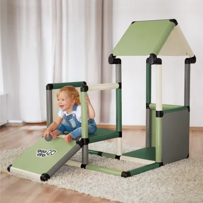 A baby is playing on a modular play structure indoors.