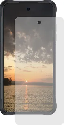 A smartphone with a screen protector applied, showing a sunset over water.
