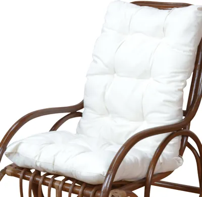 A white cushion on a brown rattan chair.