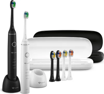 A set of electric toothbrushes and accessories, including two toothbrushes (one black, one white), a charging base, a travel case, and four replacement brush heads.