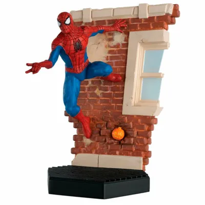 A Spiderman figurine climbing a brick wall with a window.