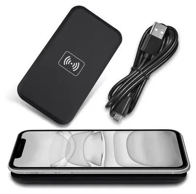 A black wireless charger and a USB cable are shown next to an iPhone.