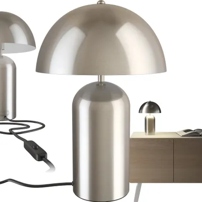 Three silver mushroom-shaped table lamps are shown against a white background. One lamp is in the foreground, and two are in the background. A small portion of a wooden cabinet is visible on the right side, with a small lamp on it.