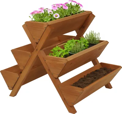 A wooden tiered planter with flowers and herbs.