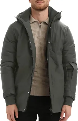 A man wearing a gray winter jacket over a beige sweater.