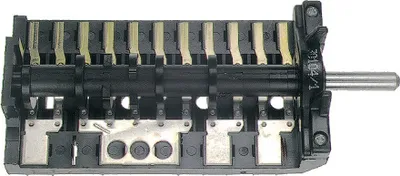 A close-up view of a rotary switch with multiple contacts and a metal shaft, set against a white background.