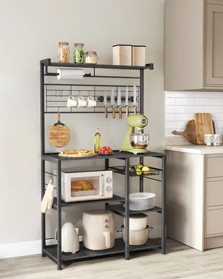A kitchen baker's rack filled with various kitchen appliances and accessories.