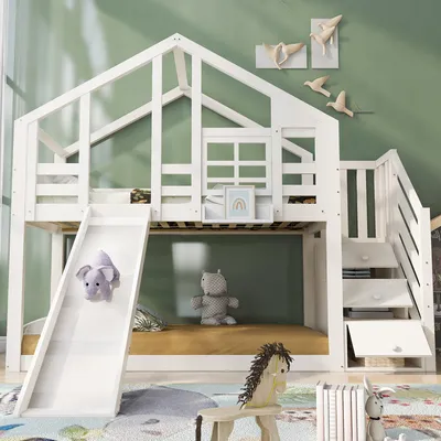 A white bunk bed with a slide and stairs, decorated with stuffed animals and wall art, in a child's room.