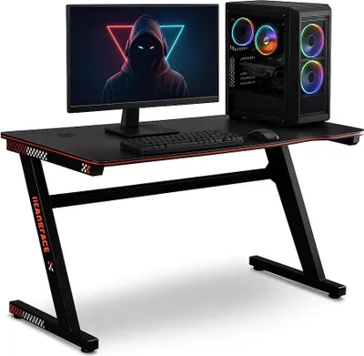 A gaming desk setup with a monitor, computer tower, keyboard, and mouse.