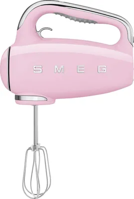 A pink Smeg hand mixer with silver accents is shown against a white background.