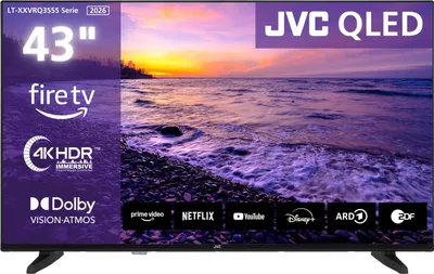 A television screen displaying a sunset over a beach, with various logos and text overlays indicating features and brands.