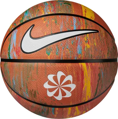A close-up view of a basketball with a colorful, marbled design and Nike logos.