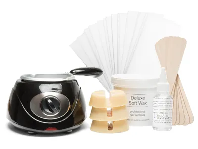 A collection of items for a waxing hair removal kit, including a wax warmer, wax beads, wax strips, and applicators, arranged on a white background.