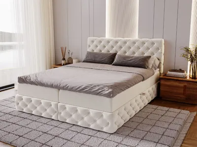 A bedroom scene featuring a large boxspring bed.
