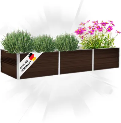 A long, dark brown planter box with silver trim, filled with green plants and pink flowers. A label with the German flag and text is attached to the front.
