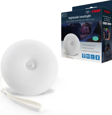 A product box for a Reer NightGuide SmartLight is shown next to the product itself. The box displays an image of a child sleeping in bed with the nightlight on, and lists product features.