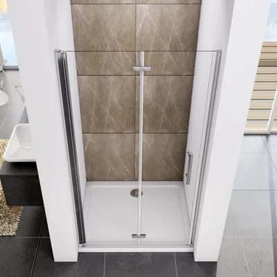 A modern shower enclosure with glass doors and silver-colored hardware, set against a tiled wall in a bathroom.