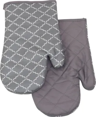 Two oven mitts are shown side-by-side against a white background. The mitt on the left has a grey and white quatrefoil pattern, while the mitt on the right is a solid grey with quilted stitching.