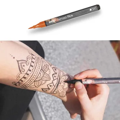 A person is drawing a henna tattoo on their arm with a KREUL Tattoo Pen.