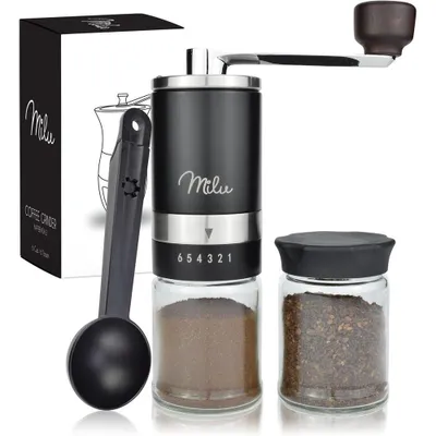 A manual coffee grinder set with its packaging and accessories, displayed against a white background.