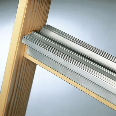 A close-up view of a metal rail attached to a wooden ladder rung.