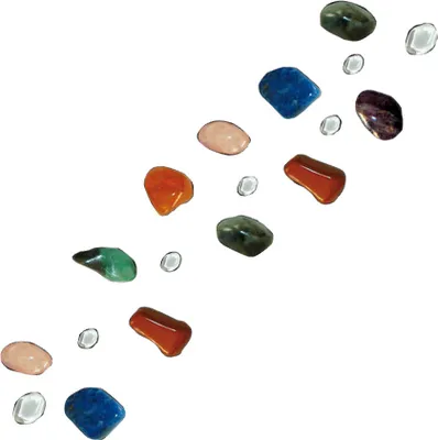 A collection of colorful, polished stones and clear, small glass beads arranged diagonally on a white background.