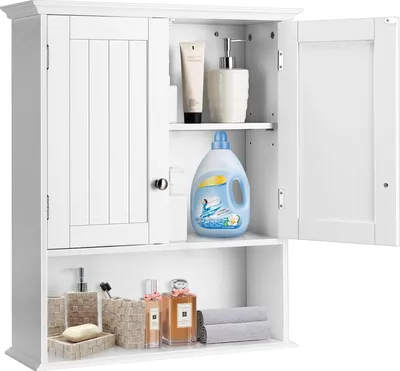 A white wooden bathroom cabinet with two doors and open shelves, filled with various bathroom products.