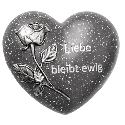 A heart-shaped memorial decoration with a rose and text.