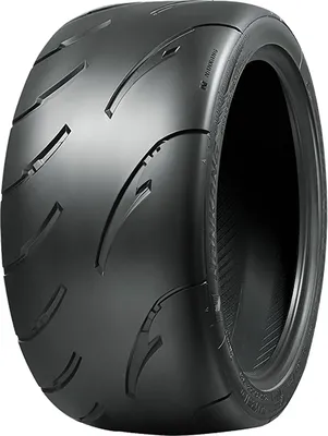 A close-up studio shot of a single black tire.