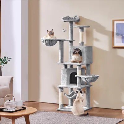 A multi-level cat tree with several cats on it, placed in a living room setting.