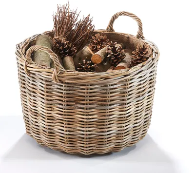 A round rattan basket filled with natural decorative items like pine cones and branches, set against a white background.