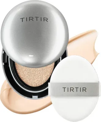 A cushion foundation compact with its puff and swatches of foundation.