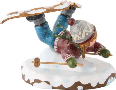 A figurine of a skier falling on snow.