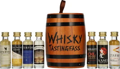 A collection of miniature whisky bottles arranged around a wooden barrel-shaped container, presented on a white background.