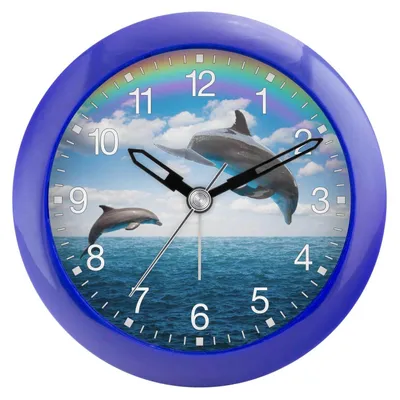 A close-up of a blue alarm clock with a dolphin and rainbow design.