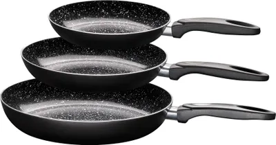 Three black frying pans of different sizes stacked on top of each other against a white background.