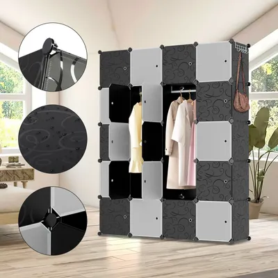 A modular wardrobe system with black and white panels, some with a decorative pattern, set up in a room with a window and plants.