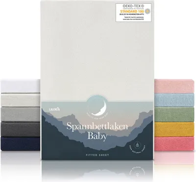 A product shot of baby fitted sheets in various colors, with a main product shot of an ivory fitted sheet in the center.