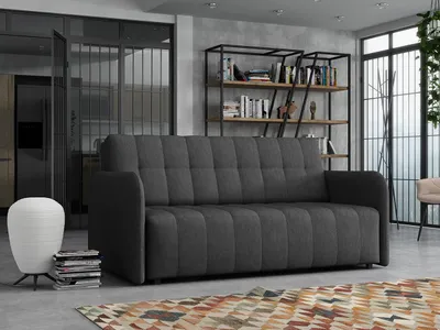 A modern living room with a sofa, bookshelf, and lamp.