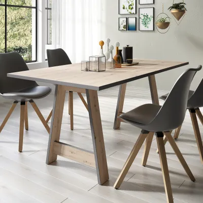 A dining table with chairs in a modern room setting.