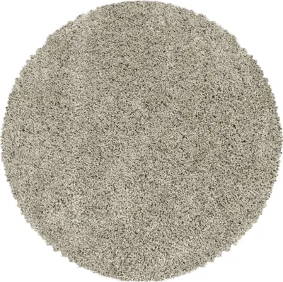 A round, shaggy rug with a high pile.