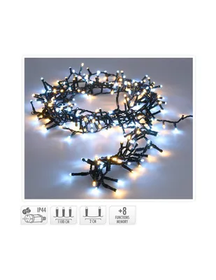 A string of LED cluster lights with both warm white and cool white bulbs, arranged in a circular pattern on a light gray surface.